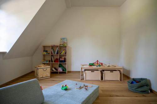 a room with a table and a desk with toys in it at Seegut Zeppelin in Friedrichshafen