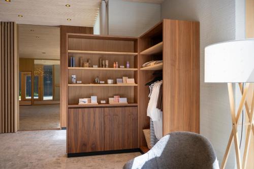 a room with a closet with a chair and a lamp at Seegut Zeppelin in Friedrichshafen