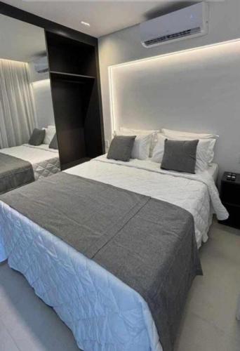 two beds in a hotel room with at Porto Alto in Ipojuca