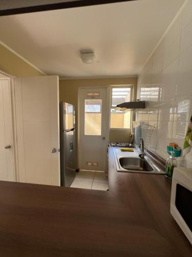 a kitchen with a sink and a counter top at Casa condominio Pucón in Pucón