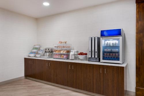 a kitchen with a counter with a refrigerator at Comfort Inn & Suites Gaylord in Gaylord