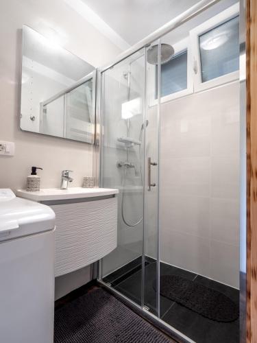 a bathroom with a shower and a sink at Villa Badi in Malinska