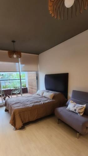 a bedroom with a large bed and a couch at Alma solar in Federación