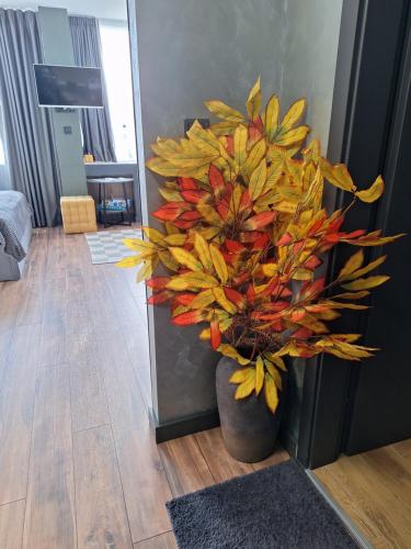 a vase with a plant in the corner of a room at Студио Даневски-Balkan Tower in Gabrovo