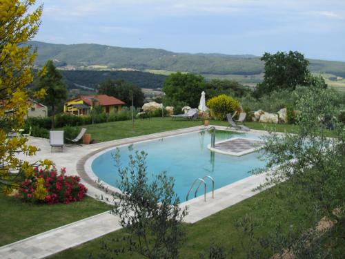 a swimming pool in a garden with a view at Agriturismo Borghetto Il Montino in Rapolano Terme
