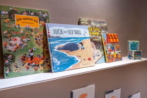 a shelf with some books on it at Hotel Maier in Friedrichshafen