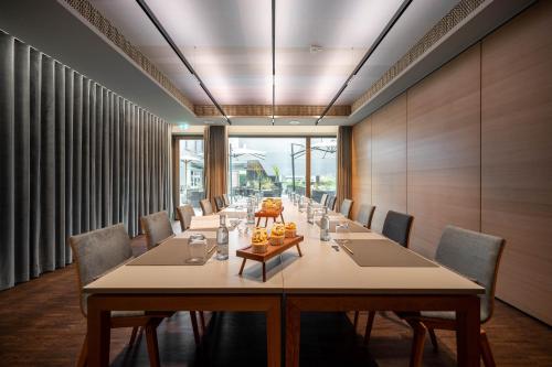 a conference room with a long table and chairs at Hotel Maier in Friedrichshafen