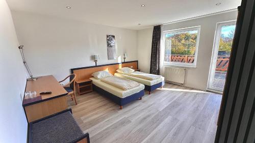 a hotel room with a bed and a desk at Bootshaus Hamm in Hamm