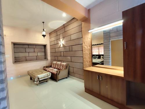 a living room with a couch and a mirror at Gopal Home Stay & Guest House in Jodhpur
