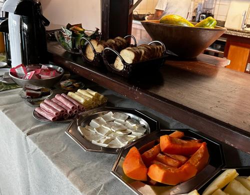 a table with a tray of food on a counter at Pousada Villa Aman in Paraty