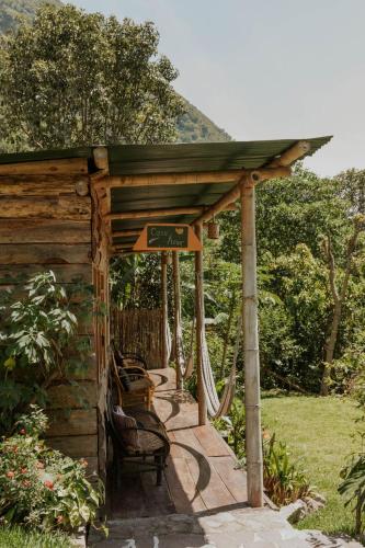 a gazebo with chairs and a hammock at Saasil Retreat in Tzununá