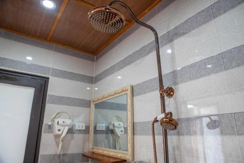a bathroom with a shower and a mirror at TRUC LAM HOTEL in Lao Cai