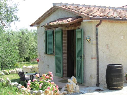 a small house with green shutters on the door at Agriturismo Borghetto Il Montino in Rapolano Terme