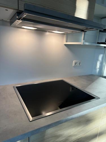 a kitchen with a stainless steel counter top at Ferienwohnung "Dream Suite" - im Coburger Wonderland - Ihr Zuhause auf Zeit! in Coburg