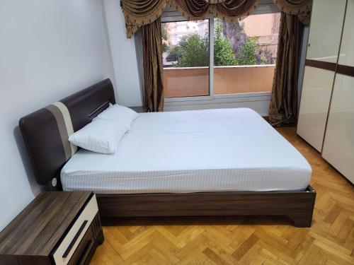 a bed in a room with a window at Pharana Residence in Alexandria