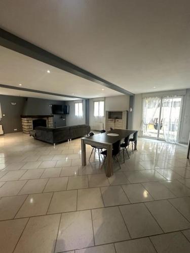 un grand salon avec une table et des chaises dans l'établissement Belle maison à la campagne, à Colligis-Crandelain