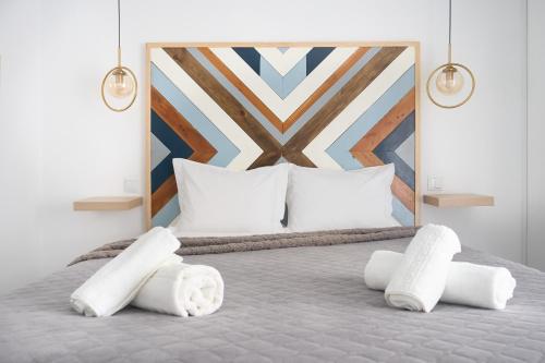a bedroom with a bed with white pillows at VintageHouse in Campo Maior