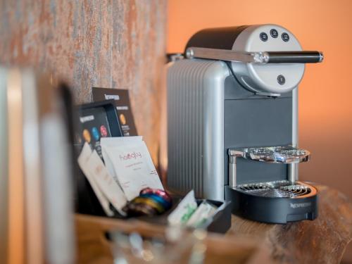 a coffee maker sitting on top of a table at Tottington Manor Hotel in Henfield