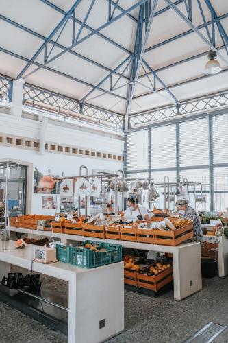 a bakery with two people working in a bakery at Casa Morgados - Grândola Guesthouse in Grândola