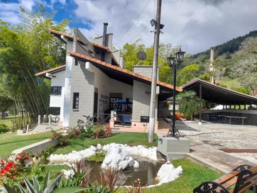 a house with a pond in front of it at Hotel MACA lago calima in Calima