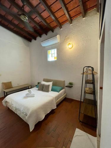 a bedroom with a bed and a ladder in it at Lotus Central Hotel in Santa Marta