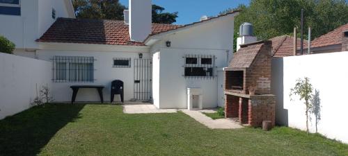 a white house with a yard in front of it at La Mary in Mar del Plata