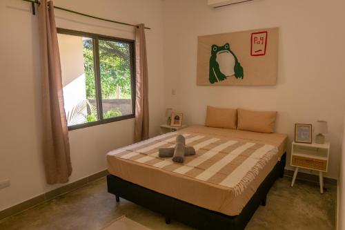 a bedroom with a bed and a window at MY - Cosy Lodges in Paraíso