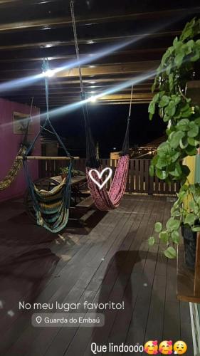 a couple of hammocks hanging from a ceiling at Morada Sol e Lua Container Guarda do Embaú com Ar condicionado in Guarda do Embaú