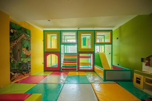a brightly colored room with colorful floors and windows at HOTEL ROYAL MOUNTAIN in Divčibare
