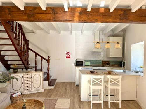 a kitchen with white cabinets and a kitchen island at Villa Tité in Oviedo