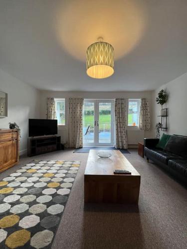 a living room with a couch and a coffee table at West House Mews C in Dunston