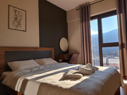 a bedroom with a large bed with towels on it at Anika Luxury apartment at Diamond center in Skopje