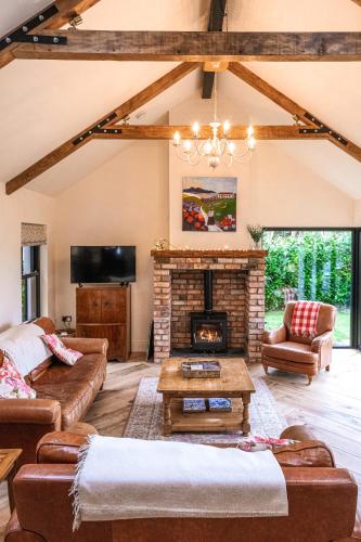 a living room with a fireplace and a tv at Bramble Cottage, hidden gem in Comber near Belfast in Comber