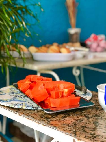 a plate of watermelon cubes on a table at Pousada Turquesa By Gente Bonita in Búzios