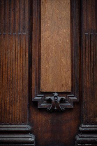 a wooden door with a metal object on it at Hôtel Le Rapp in Colmar