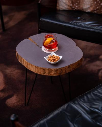 a coffee table with a bowl of food on it at Hôtel Le Rapp in Colmar