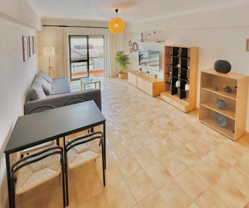 a living room with a couch and a table at T1 Vista Baía Monte Gordo in Monte Gordo