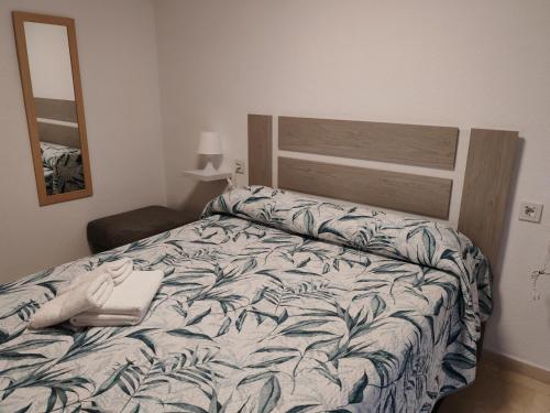 a bedroom with a bed with a laptop on it at Las Palmeras in Matalascañas