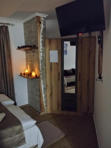 a room with a door leading to a room with a bed at Lela Kop in Kopaonik