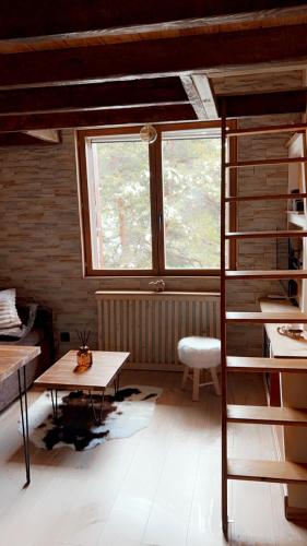 un salon avec une table et une fenêtre dans l'établissement Petit Ours Blanc, à Gréolières