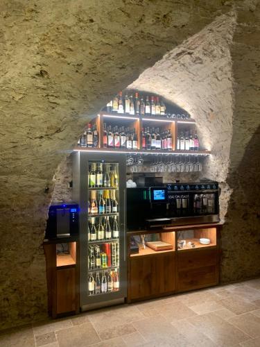 a refrigerator filled with lots of bottles of alcohol at Villa San Liberale - Suites & Wellness - Villa Veneta in Feltre