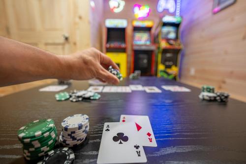 a person playing a game of poker in a casino at The Wilderness Cabin - Shenandoah Getaway - HotTub, Arcade, RiverAccess in Shenandoah