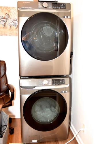 two washing machines are stacked next to each other at Handsome Home Renovated - close to Metro in Lanham