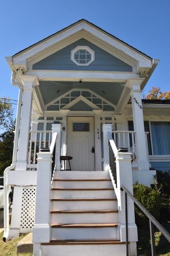 a house with a white porch and stairs at Handsome Home Renovated - close to Metro in Lanham