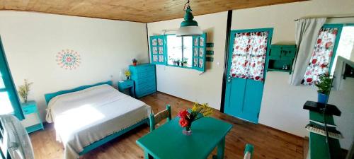 a bedroom with a bed and a table in it at La casita Espiritual in San Rafael