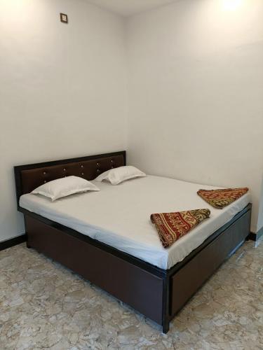 a bed with two pillows on it in a room at PNP NIVAS Holiday Home in Nagaon