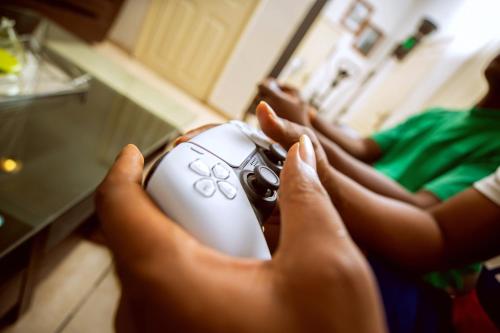 a person holding a computer mouse in their hands at Lauras cozy 2 bedroom apartment in Lagos