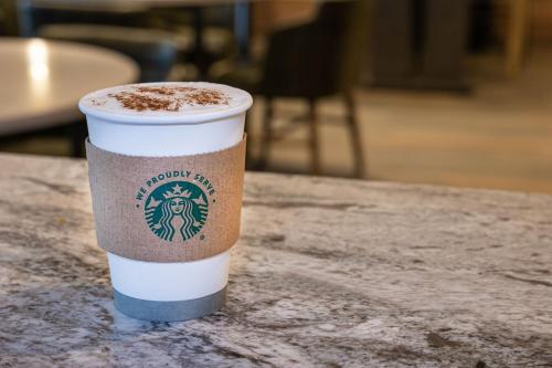 a cup of coffee sitting on a table at Marriott Boston Quincy in Quincy