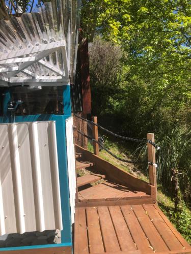 a wooden ramp leading up to a house with a gate at Heron Hideaway at First Light Rangihaeata Retreat in Rangihaeata