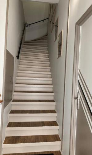 a staircase leading up to a stair case in a building at La tranquillité en centre-ville avec terrasse in Limoux